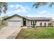 Charming single-story home with well-maintained landscaping and a two-car garage at 9235 Everwood St, Orlando, FL 32825