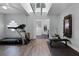 Workout room with a high ceiling, exercise equipment, and an open entry to the bathroom at 9235 Everwood St, Orlando, FL 32825