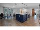 Open-concept kitchen with an island and wood-look floors at 9235 Everwood St, Orlando, FL 32825