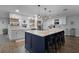 Bright kitchen with island, white cabinets, stainless appliances and bar stool seating at 9235 Everwood St, Orlando, FL 32825