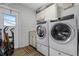 Laundry room with newer model washer and dryer and an exterior door at 9235 Everwood St, Orlando, FL 32825