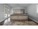 Bright main bedroom with sliding doors to the backyard, light wood floors and a king bed at 9235 Everwood St, Orlando, FL 32825