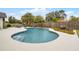 Backyard pool surrounded by lush tropical landscaping and fencing for privacy at 9235 Everwood St, Orlando, FL 32825