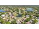 Beautiful aerial view of a lovely residential community with mature trees, ponds, and a golf course at 442 Flora Creek Ct, Lake Mary, FL 32746