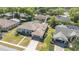 Expansive aerial view showcasing the home, landscaped yard, tile roof, and screened-in pool of a neighboring house at 442 Flora Creek Ct, Lake Mary, FL 32746