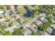Aerial view of a neighborhood with well-maintained homes, lush landscaping, and a scenic pond at 442 Flora Creek Ct, Lake Mary, FL 32746