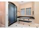 This spacious bathroom boasts a soaking tub with a black marble surround and a glass enclosed shower at 442 Flora Creek Ct, Lake Mary, FL 32746