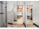 A luxurious bathroom with a soaking tub and glass-enclosed shower is seen through mirrored closet doors at 442 Flora Creek Ct, Lake Mary, FL 32746