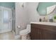 Cozy bathroom features a modern vanity, decorative mirror, and a walk-in shower with glass door at 442 Flora Creek Ct, Lake Mary, FL 32746