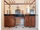 Charming bathroom with dual wood vanities, vessel sinks, and a large mirror, complemented by decorative lighting at 442 Flora Creek Ct, Lake Mary, FL 32746