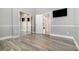 Bright bedroom with mirrored closet doors, hardwood floors, and a view into the hallway at 442 Flora Creek Ct, Lake Mary, FL 32746