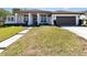 Charming one-story home featuring manicured landscaping, a two-car garage, and a welcoming entrance at 442 Flora Creek Ct, Lake Mary, FL 32746