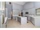 Spacious kitchen featuring grey cabinets, marble countertops and backsplash, and modern stainless steel appliances at 442 Flora Creek Ct, Lake Mary, FL 32746