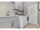 Well-equipped laundry room with modern machines, stylish cabinets and countertop space at 442 Flora Creek Ct, Lake Mary, FL 32746