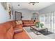 Bright living room boasting a large leather couch, modern decor, and lots of natural light at 442 Flora Creek Ct, Lake Mary, FL 32746