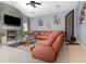 Comfortable living room showcasing a stone fireplace, a large leather couch, and stylish décor at 442 Flora Creek Ct, Lake Mary, FL 32746