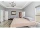 Spacious main bedroom with tray ceiling, chandelier, and natural light from the windows at 442 Flora Creek Ct, Lake Mary, FL 32746