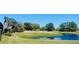 Picturesque pond view overlooking the lush golf course and mature trees, offering a serene setting at 442 Flora Creek Ct, Lake Mary, FL 32746