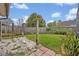 Fenced-in backyard space offers both grass and sandy areas at 1002 Ohanlon Ct, Oviedo, FL 32765