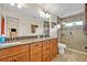 Main bathroom features double sinks, vanity with drawers, and a walk-in shower at 1002 Ohanlon Ct, Oviedo, FL 32765