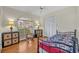 Cozy bedroom with iron bed frame, rocking chair near window, and plenty of storage at 1002 Ohanlon Ct, Oviedo, FL 32765