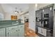 Kitchen view showcases the breakfast bar, black refrigerator, and open floor plan at 1002 Ohanlon Ct, Oviedo, FL 32765