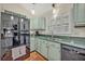 Bright kitchen featuring black appliances, tile floors, and ample countertop space at 1002 Ohanlon Ct, Oviedo, FL 32765