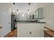 This kitchen features light green cabinets, black appliances, and tile floors at 1002 Ohanlon Ct, Oviedo, FL 32765