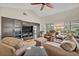 Spacious living room featuring media center and sliding glass doors to the backyard at 1002 Ohanlon Ct, Oviedo, FL 32765