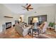 Well-lit living room with a fireplace, media center, and comfortable seating at 1002 Ohanlon Ct, Oviedo, FL 32765