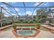 Relaxing screened pool area with lush landscaping, creating a private oasis for outdoor enjoyment at 1002 Ohanlon Ct, Oviedo, FL 32765