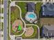 Bird's eye view of the community featuring the pool, playground, and neighborhood layout at 1195 Boardwalk Pl, Kissimmee, FL 34747