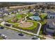 Aerial view of the community park, showcasing the pool, playground, and surrounding residences at 1195 Boardwalk Pl, Kissimmee, FL 34747