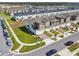 Aerial view of multi-story townhouses featuring well-maintained landscaping and sidewalks at 1195 Boardwalk Pl, Kissimmee, FL 34747