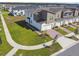 Aerial view of a two-story townhouse, manicured lawn, brick driveway and sidewalks at 1195 Boardwalk Pl, Kissimmee, FL 34747