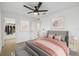 Bright bedroom features a ceiling fan, walk in closet, carpet flooring, and neutral wall color at 1195 Boardwalk Pl, Kissimmee, FL 34747