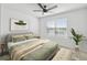 Comfortable bedroom with a ceiling fan, natural light, and neutral decor; perfect for relaxation at 1195 Boardwalk Pl, Kissimmee, FL 34747