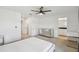 Bright primary bedroom featuring a ceiling fan, large window, and neutral carpet flooring at 1195 Boardwalk Pl, Kissimmee, FL 34747