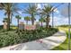 The Soleil community sign nestled amongst palm trees, shrubs, and a sidewalk at 1195 Boardwalk Pl, Kissimmee, FL 34747