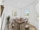 Inviting dining room with a wooden table, stylish chairs, and a window providing natural light at 1195 Boardwalk Pl, Kissimmee, FL 34747