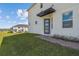 Stylish front entrance with a modern door, brick walkway, and verdant lawn, inviting guests inside at 1195 Boardwalk Pl, Kissimmee, FL 34747