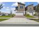 Modern two-story home with attached garage and manicured lawn on a bright day at 1195 Boardwalk Pl, Kissimmee, FL 34747