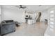 Bright, open-plan living space with modern kitchen, cozy seating, and a staircase, perfect for entertaining at 1195 Boardwalk Pl, Kissimmee, FL 34747