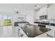 Bright, airy living space featuring a sleek kitchen, stainless steel appliances and a sliding glass door at 1195 Boardwalk Pl, Kissimmee, FL 34747
