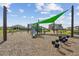 Community playground with a slide, shade, and play equipment over a soft wood chip surface at 1195 Boardwalk Pl, Kissimmee, FL 34747