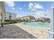 Relaxing community pool area with lounge chairs, umbrellas, and a refreshing shower at 1195 Boardwalk Pl, Kissimmee, FL 34747