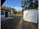 Backyard with grass, bordered by trees, and a white storage shed is visible at 1289 E Hancock Dr, Deltona, FL 32725
