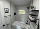 Bright bathroom with a tub and shower featuring modern fixtures and decor, plus ample shelving at 1289 E Hancock Dr, Deltona, FL 32725