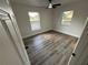 Bright bedroom featuring two windows offering plenty of natural light, and contemporary wood-look floors at 1289 E Hancock Dr, Deltona, FL 32725