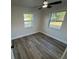 Bedroom featuring two windows offering plenty of natural light, and contemporary wood-look floors at 1289 E Hancock Dr, Deltona, FL 32725